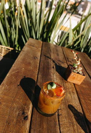 A fresh mango margarita from Los Weekenders sitting on table